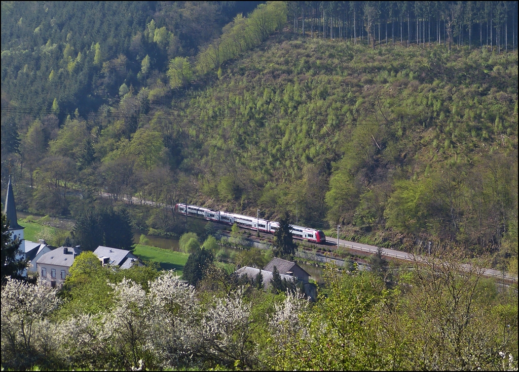 . The RB 3208 Luxembourg City - Wiltz is running along the river Wiltz in Kautenbach on May 5th, 2013.