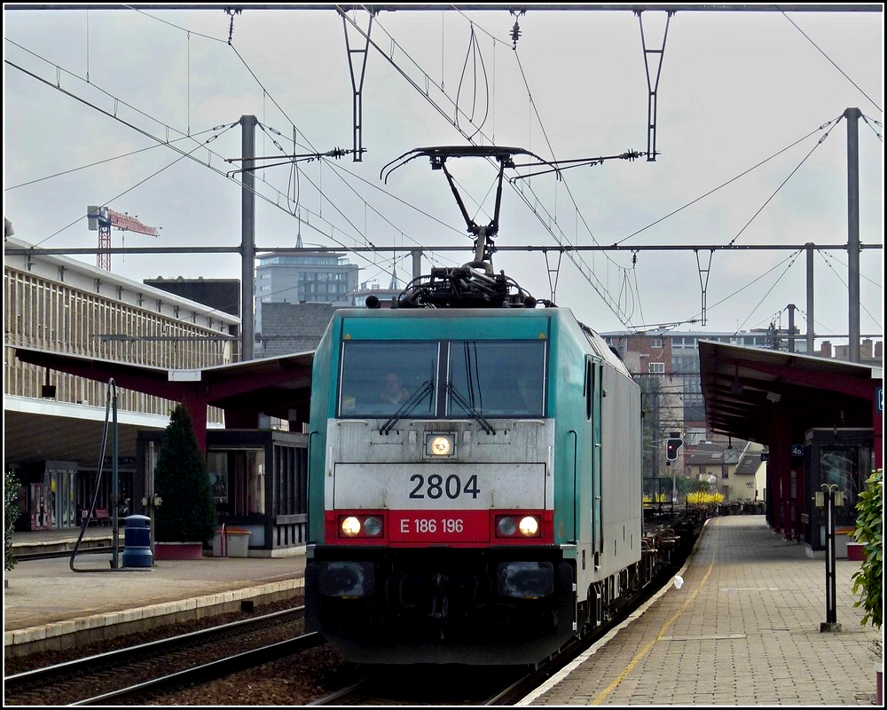 . The TRAXX HLE 2804 is hauling a freight train through the station of Hasselt on March 11th, 2011.