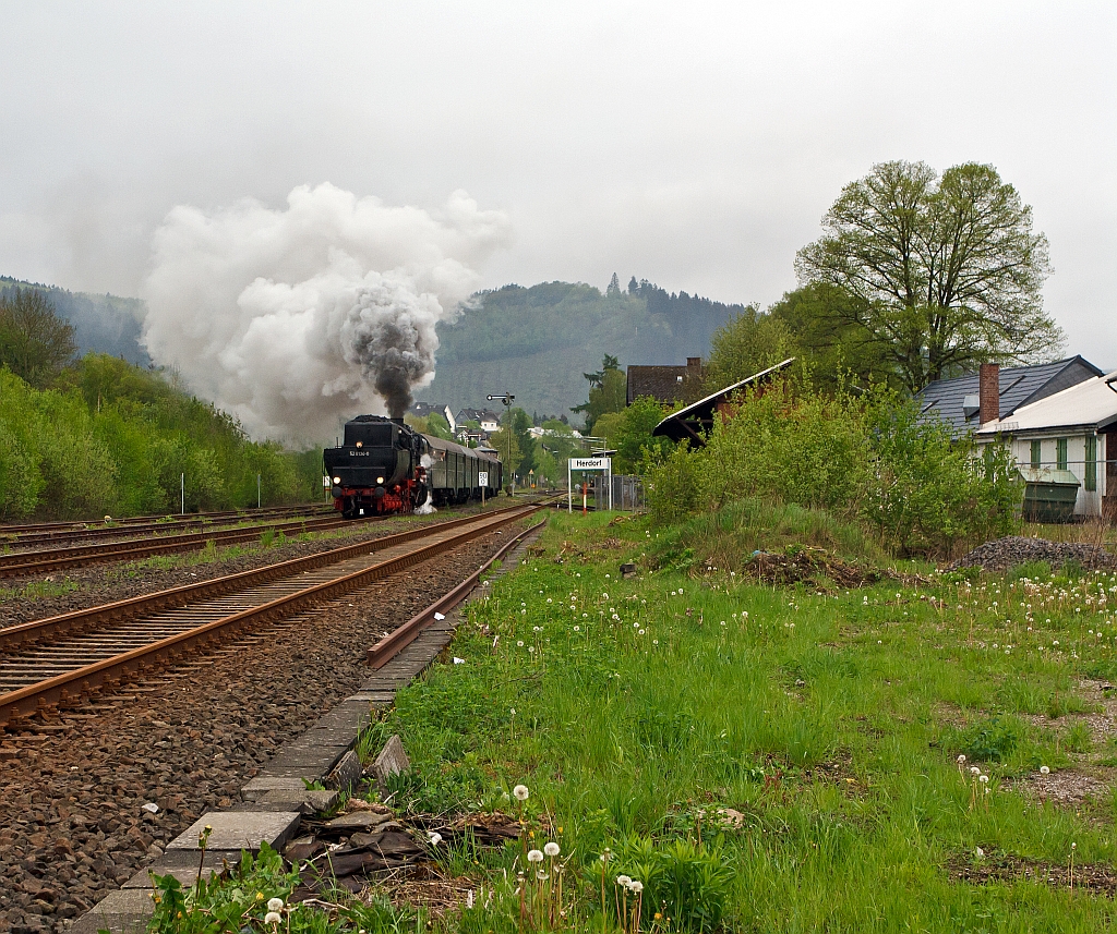 06.May 2012: Just in time clock at 8:12, drives the steam engine  52 8134-0 of the railway friends Betzdorf  from the station Herdorf,  Tender ahead in the direction of Gieen.