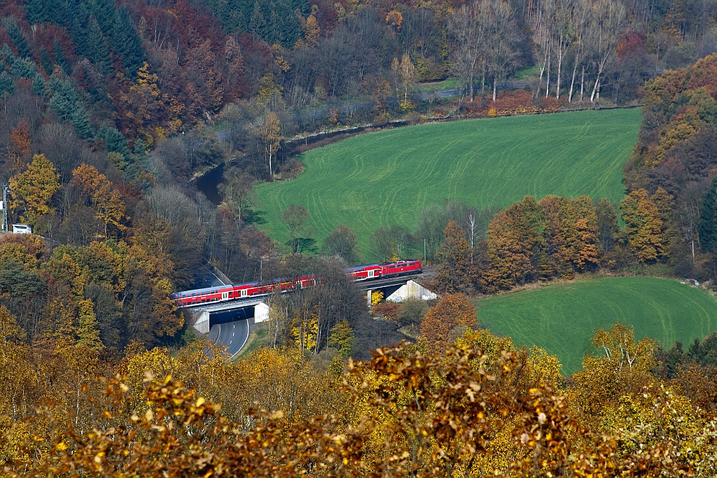 A 111er with the RE 9 on 01.11.2011 behind Kirchen-Freusburg, they drive on the track along the Sieg to Siegen. The photograph was taken from the Otto tower at Kirchen-Herkersdorf.