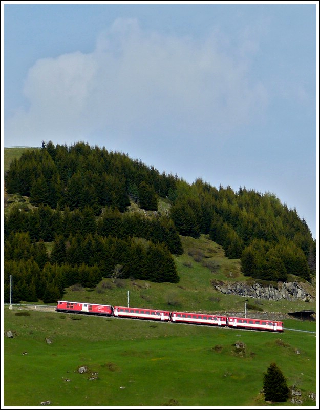 A local train to Disentis/Mustr is climbing up the track between Andermatt and Ntschen on May 24th, 2012.