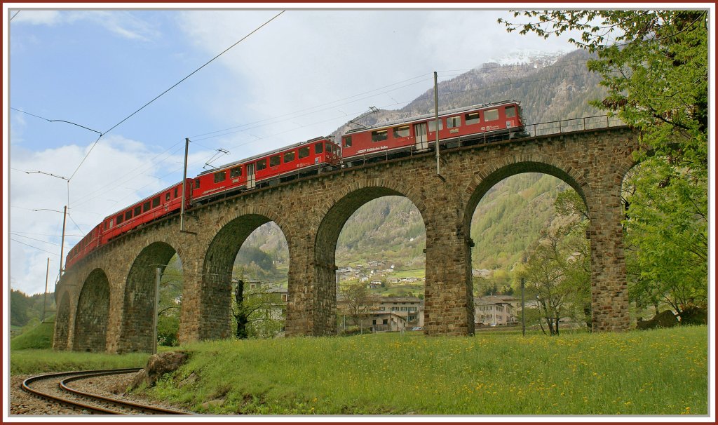 A RhB local train to St. Moritz on the famous Brusio Circle -Viaduct. 
08.05.2010