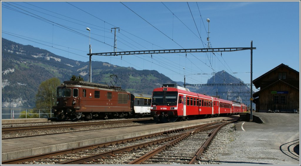 BLS Re 4/4 with a  Golden Pass  RE and a BLS local train in Leissigen. 
09.04.2011