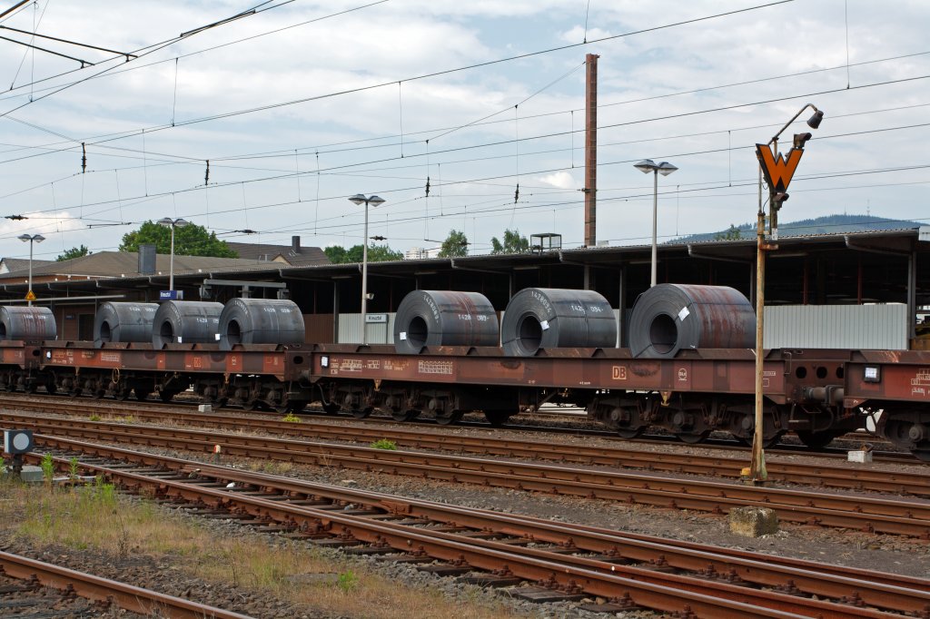 Bogie flat wagon of the DB AG with six sets of wheels, with Loading trays for coil transports (Sahmms t-710) on 17.06.2011 loaded with 3 Coil's parked in Kreuztal.
