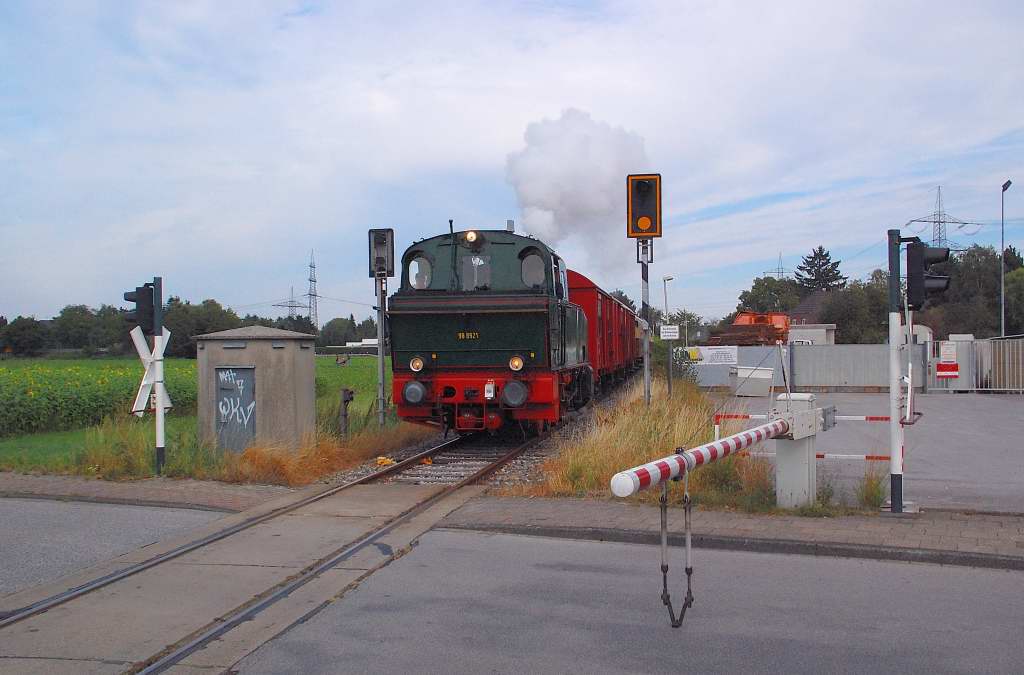 In a vew seconds the Henschel D600 steamlocomotive named Schluff owne by the city of Krefeld crosses the Industriestrae in St. Tnis near Krefeld.Sunday 2nd of septembre 2012