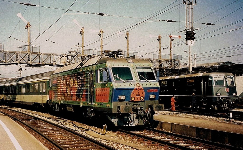 In the summer 1996 leaves the SOB Re 4/4 IV in special colours  Mrklin Metallbaukasten  Romanshorn with his  Voralpenexpress  to Luzern. 
(scanned analog photo)


