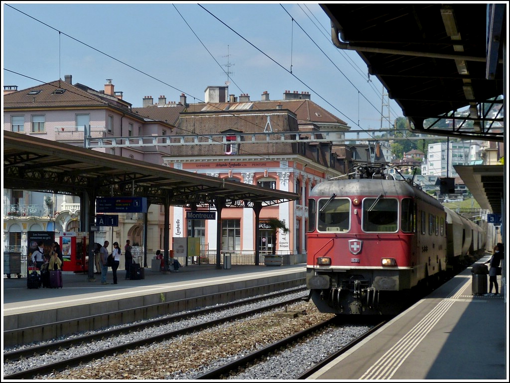Re 4/4 II 11608 is hauling a goods train through the station of Montreux on May 25th, 2012.