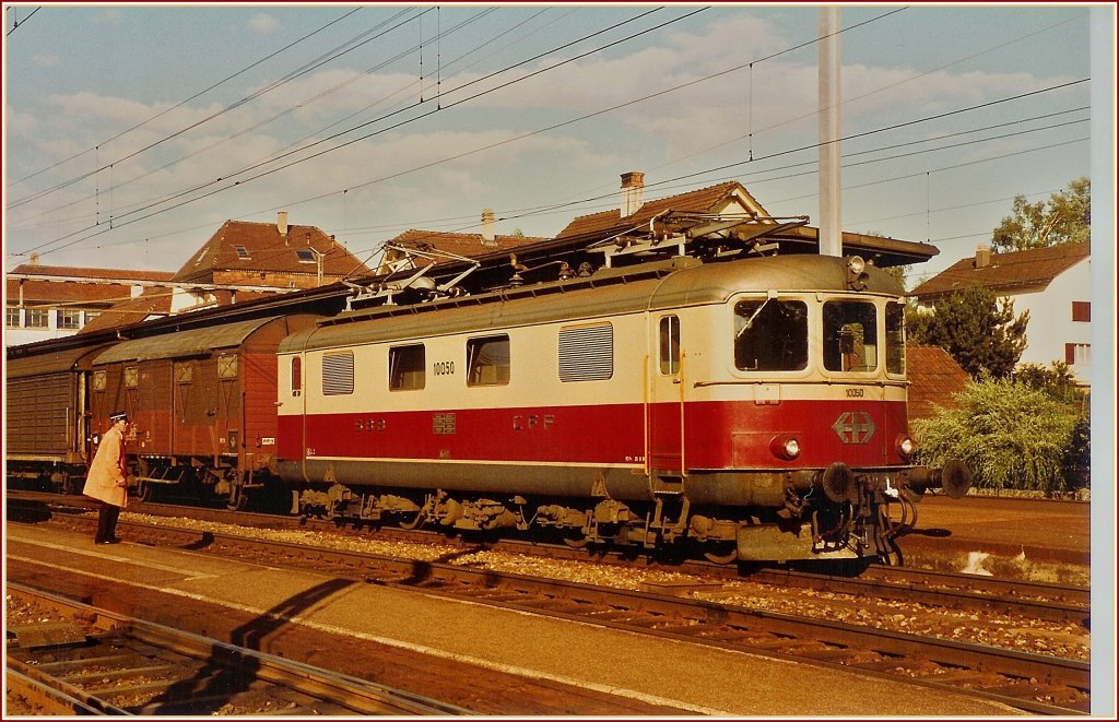 SBB Re 4/4 I 10050 with a -cargo local train in Lengnau. 
Summer 1984 / analog scanned photo