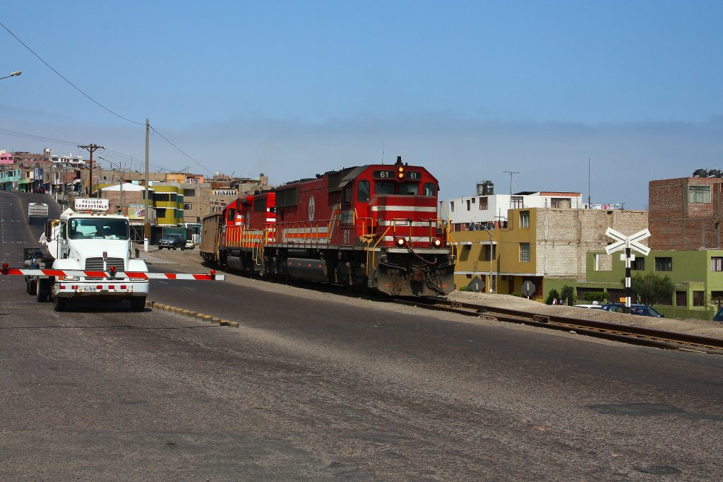 SPCC 61 & 32 slowly roll through Ilo, while a petrol truck has to wait.