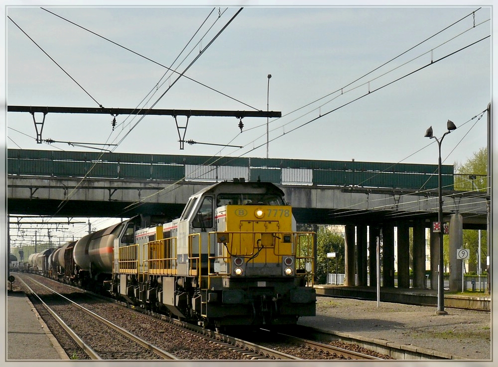 Srie 77 double header is hauling a goods train through the station Antwerpen Noorderdokken on April 24th, 2010.