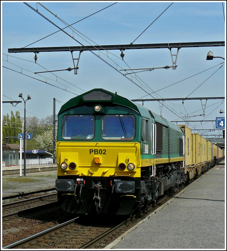 The Ascendos Rail Leasing Sarl Class 66 PB02 is hauling a freight train through the station Antwerpen-Noorderdokken on April 24th, 2010.
