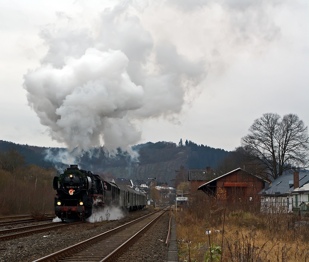 The Betzdorfer 52 8134-0 on 27.11.2011 with Santa Claus Train, between Betzdorf/Sieg and Wrgendorf. Here it comes from Betzdorf and passes through the station Herdorf.
