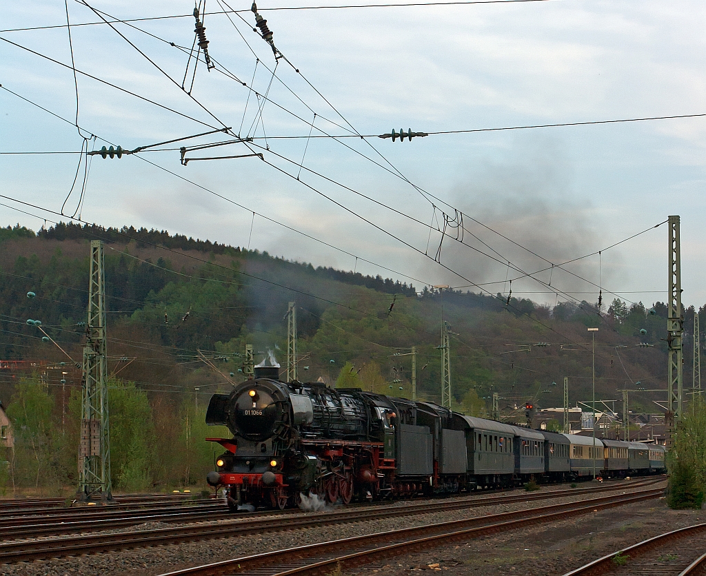 The three-cylinder express steam locomotive 01 1066 of the UEF, ex DB 012 066-7, pulls the second special train of the Eifelbahn, on the way back from Gieen over Siegen and over the track of the Sieg (KBS 460) in the direction of Cologne. Here on 28.04.2011 in Betzdorf/Sieg.