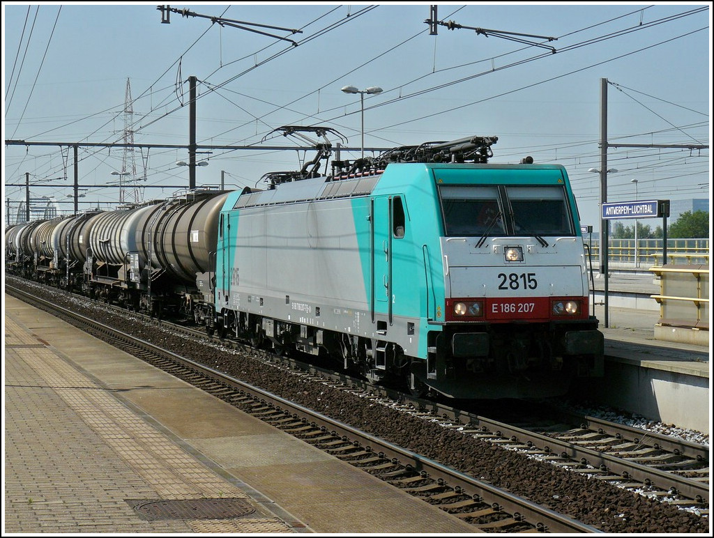 The TRAXX 2815 is hauling a freight train throug the