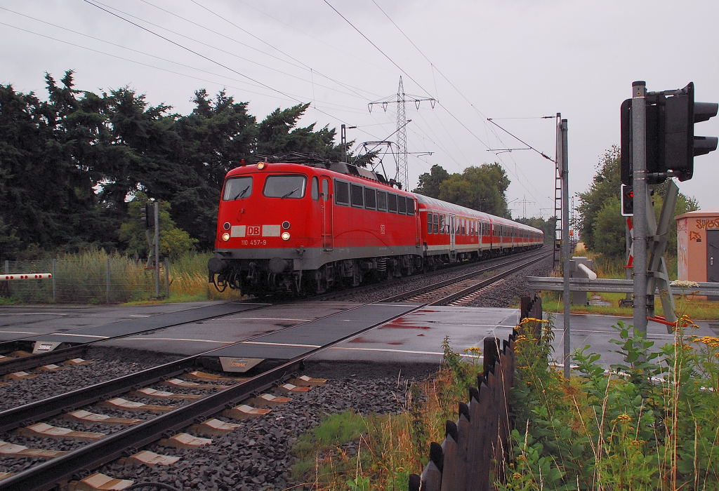 This photo shows the class 110 457-9 at the railroadcrossing Herrather Linde near Mnchengladbach. With it's train it supports the regulary regional expressline 4 to Aachen in the rushhoures. Enjoy this photo, it is only a question of time, until even the last of this locomotivclass ends at the boneyards of the republic. 16th july 2012