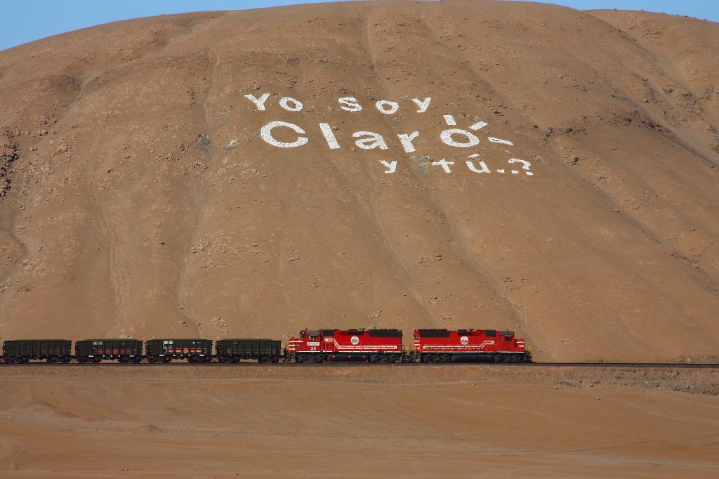 Yo soy Claro - y tu ? is an advertisement for a popular mobile telephone company in Peru, often depicted with white stones on the flanks of hills.

here, SPCC 31 & 33 pass such an over-simensioned billboard.