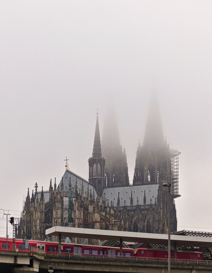 . A train of the Klner S-Bahn is arriving in Cologne main station on the foggy November 20th, 2014.