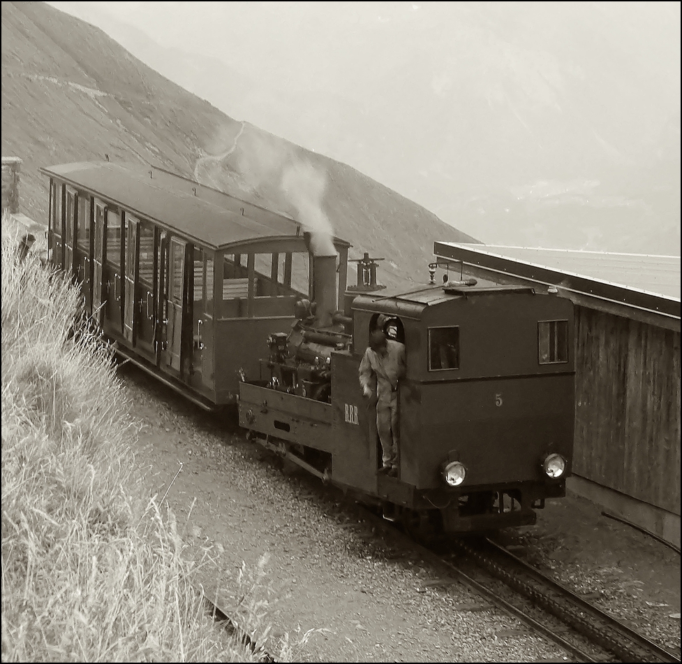 . The BRB coal fired steamer N 5 pictured with the heritage car B 1 in the upper terminus Rothorn Kulm in the evening of September 28th, 2013.