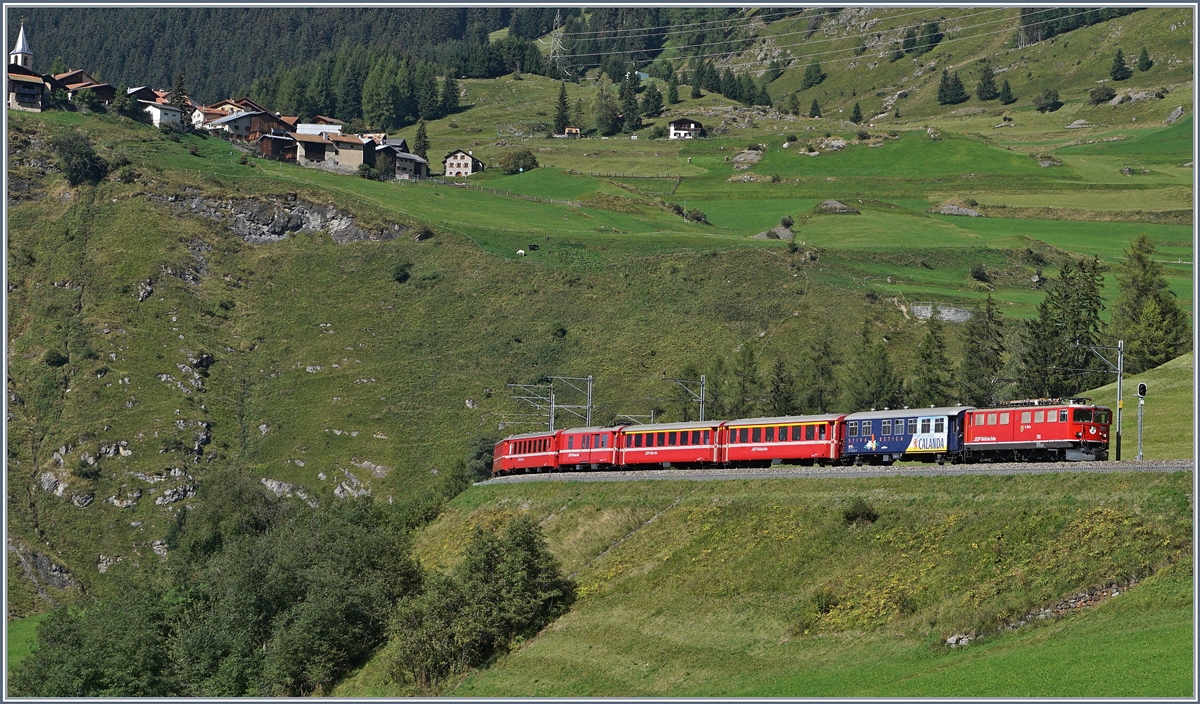 A RhB Ge 6/6 II with a Fast-Train-Service from St Moritz to Chur near Bergün, in the background the  Heidi-Moving-Village  Latsch.
14.09.2016