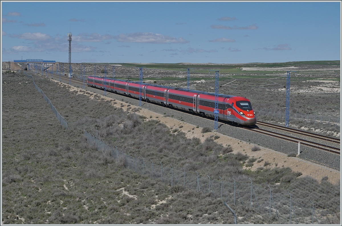  Bella Italia  in the middle of Spain and very quickly: the IRYO ETR 400 flies from Madrid at around 300 km/h to Barcelona via the high-speed line near Bujaraloz (Spain). This is the IRYO Service 6011. 

The picture shows the high-speed route at kilometer 370.5 (from Madrid) in the flat country, as we commonly imagine Spain, but interestingly, the route into the Sierre Ministra at kilometer 152.7 reaches a height of 1217 m above sea level, making it the highest high-speed route Europe!

April 18, 2024