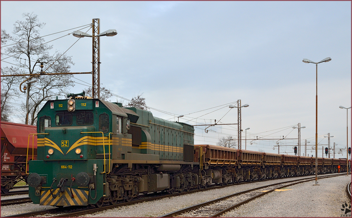 Diesel loc 664-112 with freight train is arriving on Pragersko station. /21.2.2014