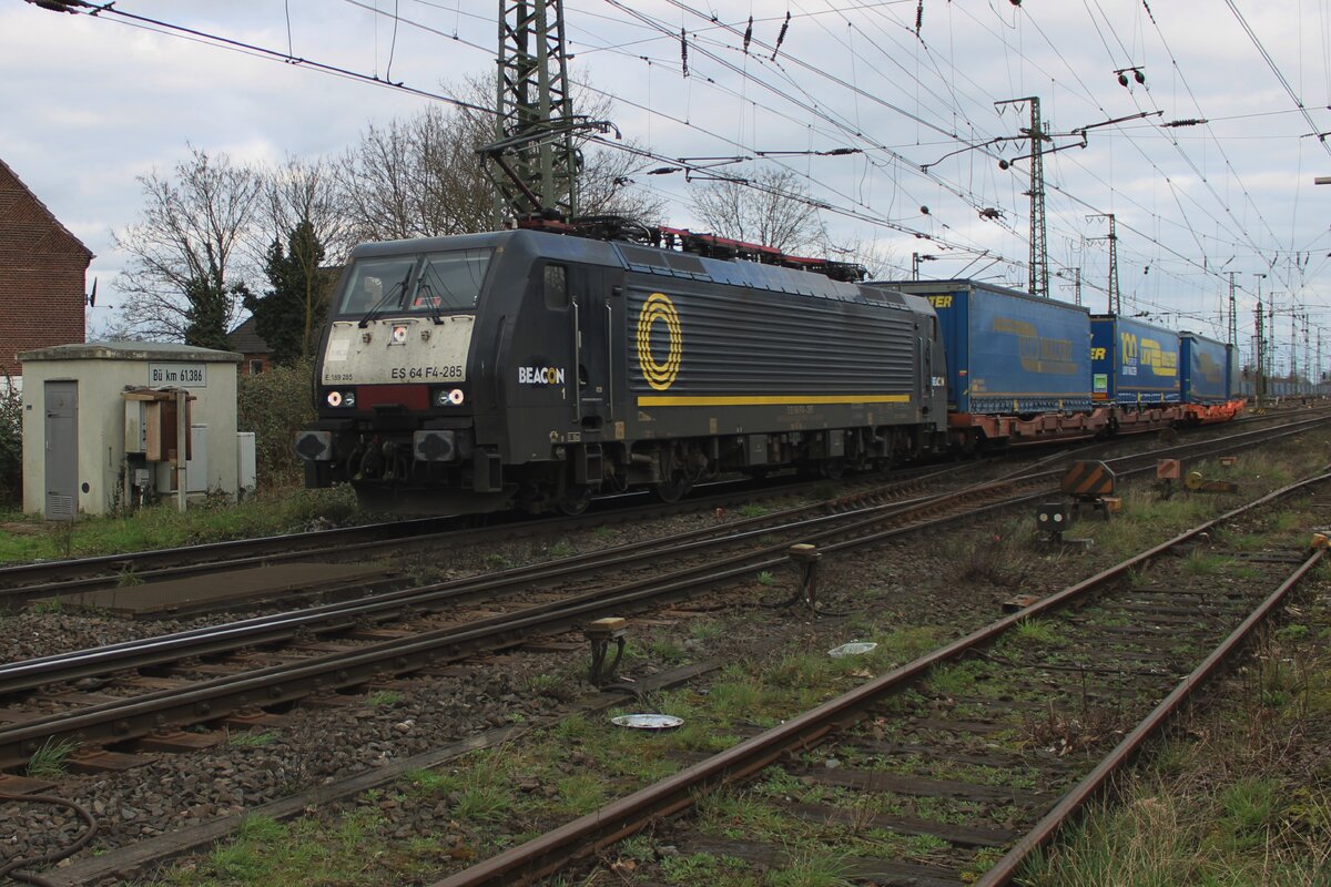 LKW Walter celebrates her first centenary with some trailers carrying celebrative text, one of which is seen in second position on this train, leaving Emmerich on 16 March 2024 with Ecco rail 189 285 at the reins.