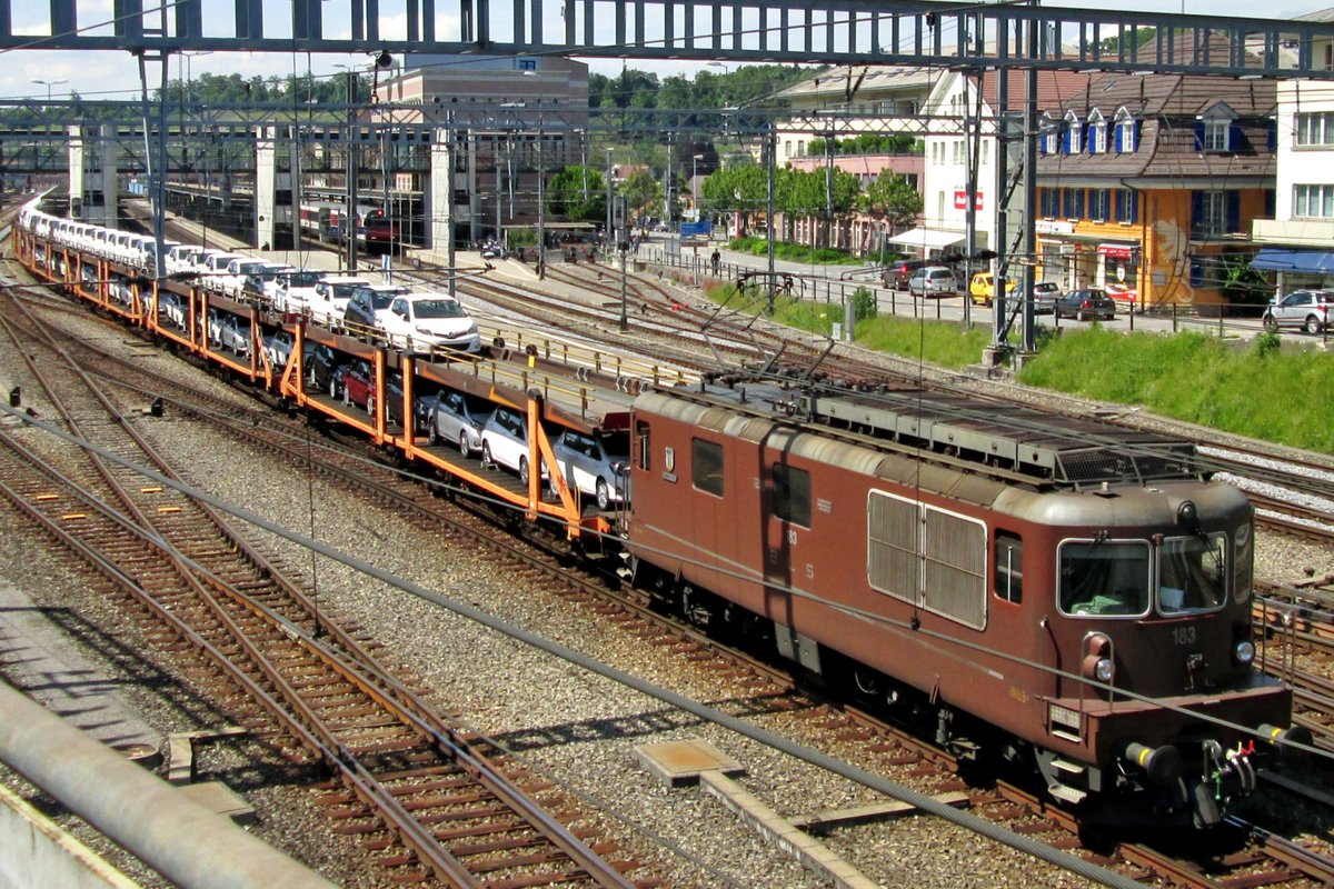 On 5 June 2014 BLS 183 hauls a train with automotives out of Spiez.