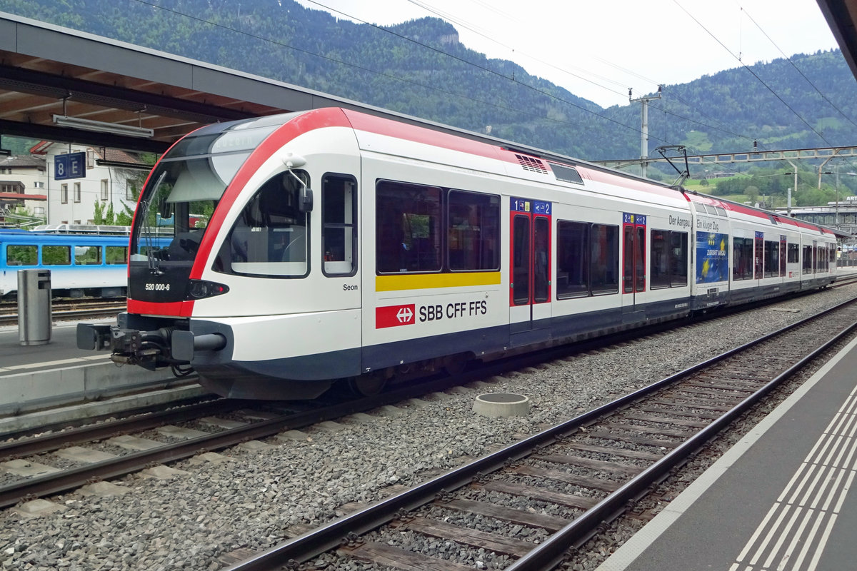 SBB 520 000 stands on 27 May 2019 in Arth-Goldau. The advertising phrase 'Der Aargauer. Ein klüger Zug' means 'the Aargau inhabitant, a smart train' but also '... a smart move' (like in chess).
