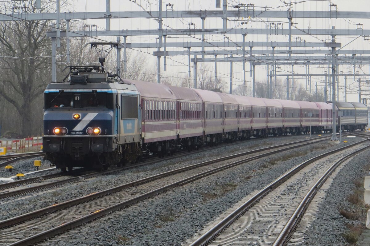TCS 102001 (ex NS 1635, Bentheimer Eisenbahn 1835) hauls a Green City Trip overnight train Praha-Eindhoven into Geldermalsen on 3 February 2022.