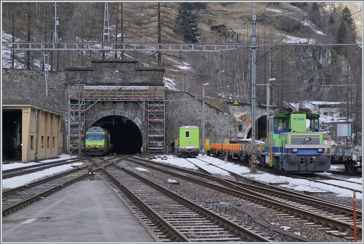 The BLS Re 465 002 (not to see) and the BLS R 465 017 with his AT1 to Kandersteg are entering in the Lötschberg-Tunnel in Goppenstein. On the left a BLS Tm 232. 

03.01.2024t 