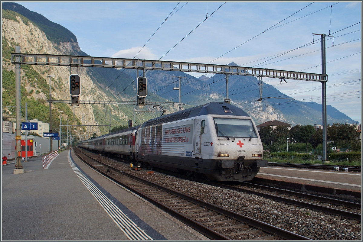 The red cross SBB Re 460 045-7 with his IR to Brig in Martigny.
28.08.2015