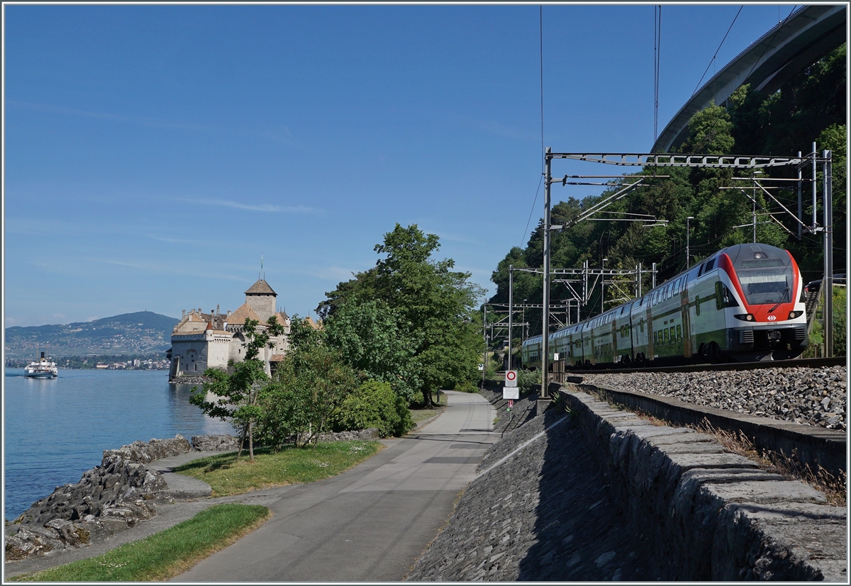 The SBB RABe 511 103 on the way to St-Maurice by the Castle of Chillon. In the background the steamer  Italie . 

21.05.2022