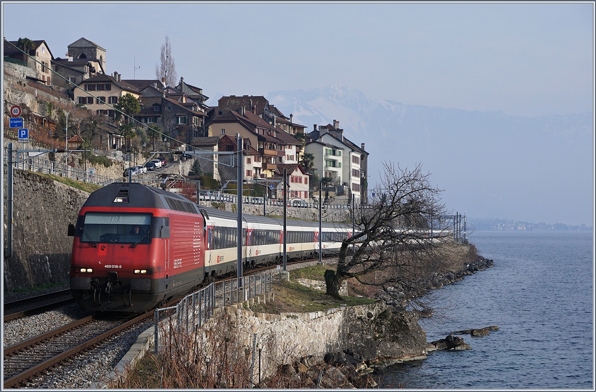 The SBB Re 460 018-5 with an IR to Geneva Airport by St Saphorin. 06.02.2018