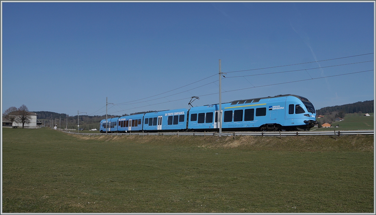 The TPF  Groupe Grisoni  TPF RABe 527 198 on the way to Bulle near Vaulruz.

02.03.2021