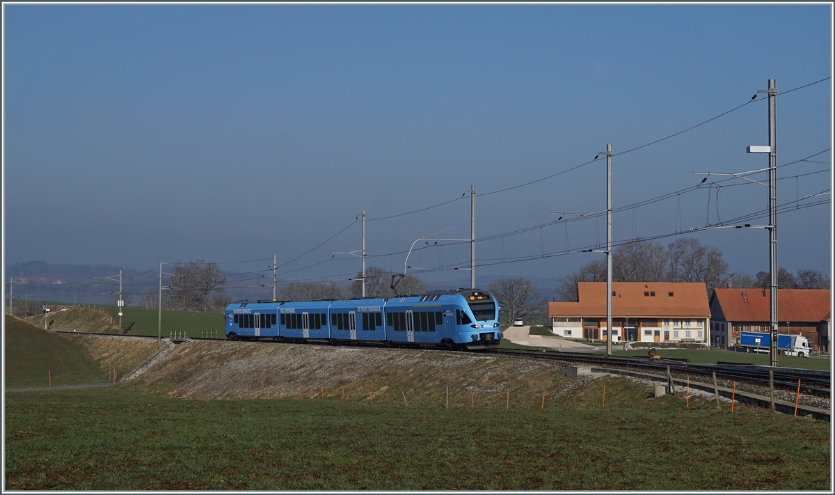The TPF RABe 527 198 on the way to Bulle by Vuisternens-devant- Romont. 

1. März 2021