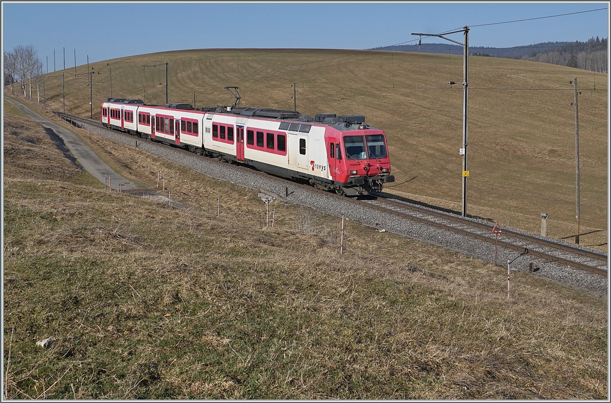 The Travys RBDe 560 384-0  Lac de Brenet  with his local service on the way to Vallorbe by Les Charbonières.

24.03.2022