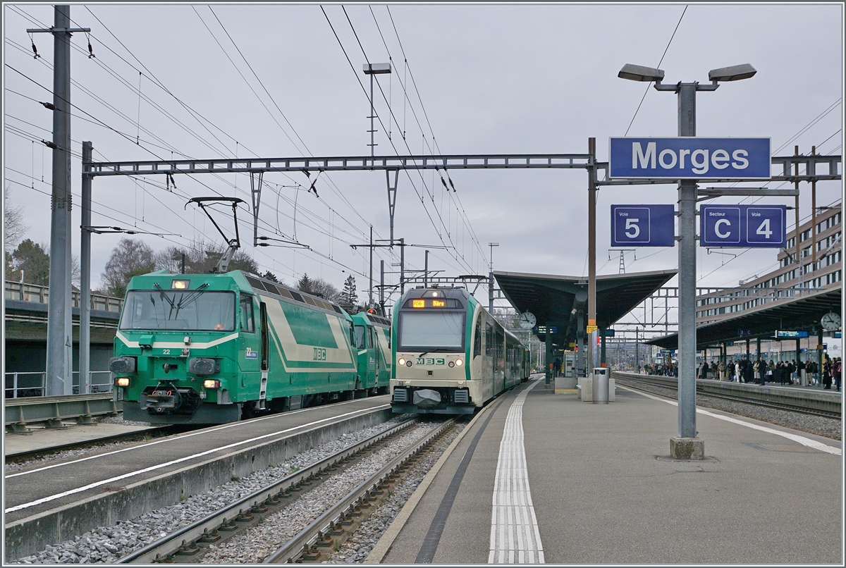 The two BAM MBC Ge 4/4 22 and 21 are now ready to depart for Apples with their gravel train in Morges. Next to it is a BAM MBC SURF Be 4/4 - B - Bt as a regional train R 56 to Biere. March 4, 2024