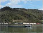 152 A goods train is meeting a ship while running through the Rhine gorge near Loreley rock on March 19th, 2010.