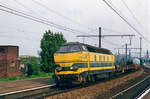 In yellow/green colours, NMBS 6238 hauls a mixed freight through Antwerpen-Dam. Antwerpen-Dam is defunct now and 6238 has been repainted in InfraBel blue.