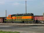 BNSF BNSF 7801 is coupled to (former Santa Fe) BNSF 6335 on the front and a gondola full of scrap steel pulled from a West Burlington, Iowa scrap yard on 11 June 2005.
