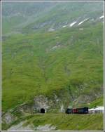 dampfbahn-furka-bergstrecke-dfb A DFB steam train pictured at the the highest station of Furka Mountain Railway (2160 m above sea level) together with the entry to the 1874 m long summit tunnel on August 1st, 2008.