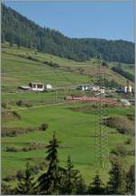 engadina Ge 4/4 II with a RE to Disentis is leaving Ardez. 
11.09.2011 
