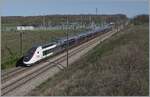 An SNCF TGV Duplex is traveling very quickly towards Paris on the Lyon Pairs high-speed line near Saint Émiland.