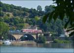 . The RE 5211 Luxembourg City - Trier is running on the Sre bridge in Wasserbillig on July 16th, 2013.