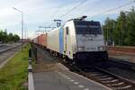 RailPool 186 536 hauls a container train through Blerick and gets photographed from the station platform on 28 May 2021.