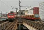 The DB 112 101-1 with an RE1 to Eisenhttenstadt and a S7 to Arensfelde are arriving at the Berlin Alexanderplatz Station.