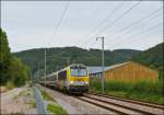 3018 is hauling the IR 117 Liers - Luxembourg City through Erpeldange/Ettelbrck on August 24th, 2012.