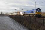 RailTraxx 266 009 hauls a tank train through Tilburg-Reeshof on 22 December 2021.