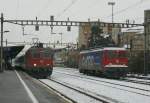 re-420-re-4-4-ii Re 4/4 II with RE to Lausanne and Ae 6/6 in Renens VD.
21.12.2009