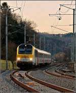 Serie 3000 3012 is heading the IR 119 Liers - Luxembourg City in Wilwerwiltz in the evening of February 8th, 2011.
